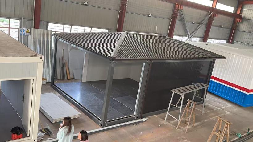 Overhead view of folding-roof modular unit frame being assembled inside Taimao factory hall